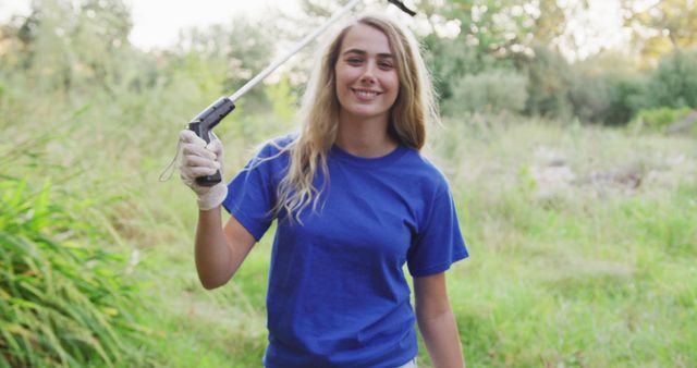 Young Female Volunteer Holding Trash Picker in Park - Download Free Stock Images Pikwizard.com