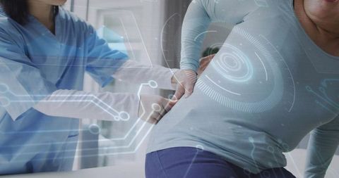 Clinician examining patient with lower back pain and ar diagnostic overlay for rehab