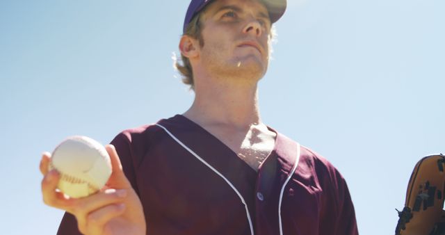 Baseball Player Holding Ball with Glove Under Clear Sky - Download Free Stock Images Pikwizard.com