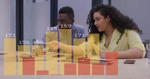 Colleagues Analyzing Financial Data in Office with Digital Charts