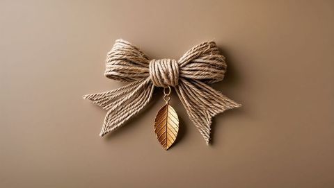 Rustic jute bow with gold leaf pendant
