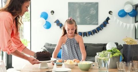 Mother and Daughter Prepare Birthday Celebration at Home