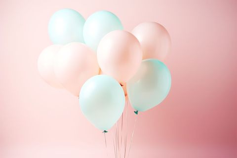 Pastel balloons on soft pink background for celebrations