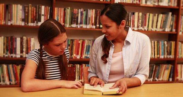 Teacher Assisting Student with Homework in Library - Download Free Stock Images Pikwizard.com