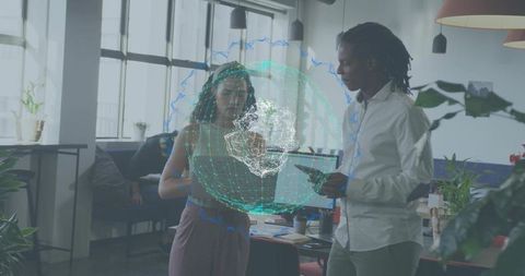 Collaborating over holographic globe visualizing data in modern open office