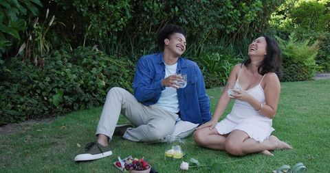 Happy Couple Enjoying Leisurely Picnic in Sunny Garden