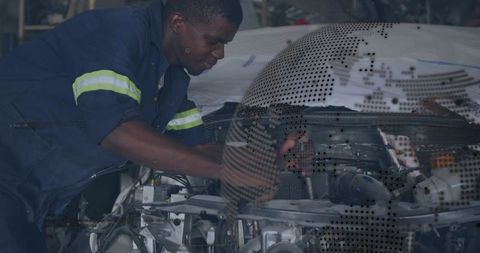 Professional mechanic repairing car engine under open hood using wrench in garage