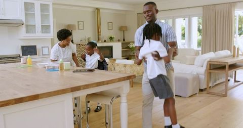 Father Assisting Son with Shoes in Cozy Family Morning Routine