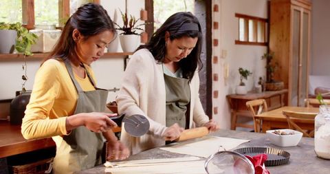 Mother and Daughter Baking Pastry in Rustic Kitchen