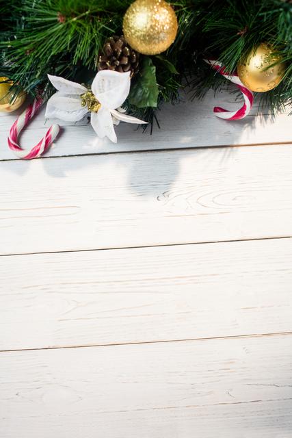 Christmas Decorations on Wooden Plank with Candy Canes and Ornaments - Download Free Stock Photos Pikwizard.com