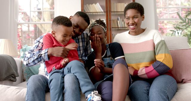 Happy African American Family Laughing Together on Couch at Home - Download Free Stock Images Pikwizard.com