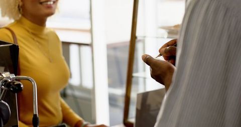 Customer Ordering Coffee in Modern Cafe Environment