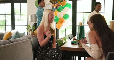 Diverse Group Preparing Birthday Décor in Modern Living Room