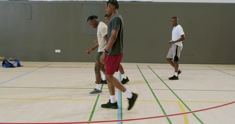 African american men training on indoor court sprinting, drills and teamwork fitness