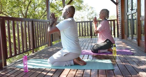 Senior African American Couple Practicing Outdoor Yoga Meditation
