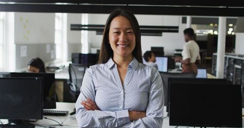 Confident Asian Businesswoman Smiling in Modern Office Environment