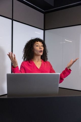 Professional Woman Leading Corporate Presentation in Modern Office