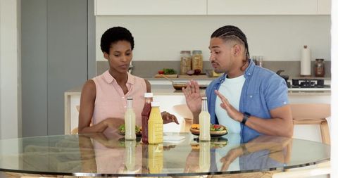 Diverse Couple Enjoying Meal at Modern Kitchen Table
