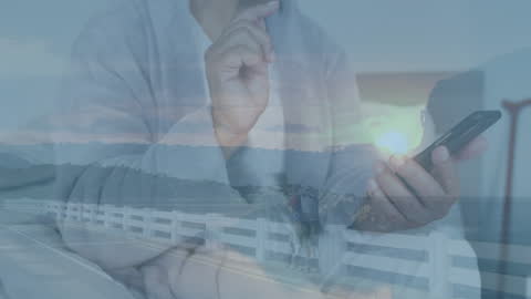 Overlay of Man Using Smartphone and Cityscape