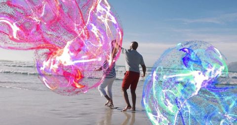 Couple Dancing with Magical Energy Orbs on Beach