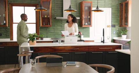 Modern Kitchen Discussion with Couples Over Documents