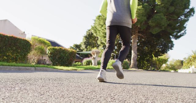 Person Jogging on Suburban Road in Morning Light - Download Free Stock Images Pikwizard.com