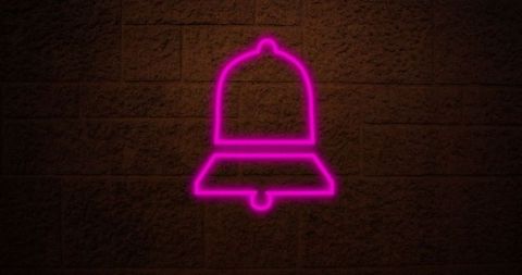 Glowing Pink Neon Bell Against Dark Brick Wall