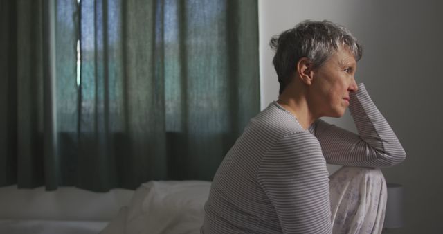 Mature Woman Sitting on Bed in Morning Light - Download Free Stock Images Pikwizard.com