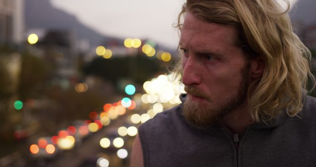 Pensive Man with Blurred City Lights in Background - Download Free Stock Images Pikwizard.com