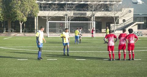 Youth soccer teams competing on school field