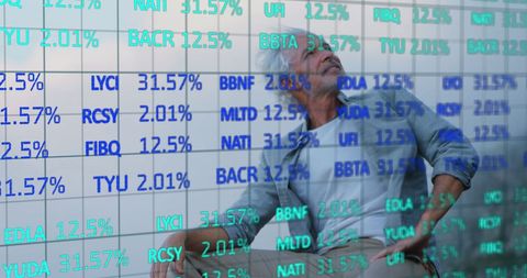 Senior man analyzing stock market data on digital screen