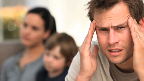 Stressed Father Experiencing Headache at Home