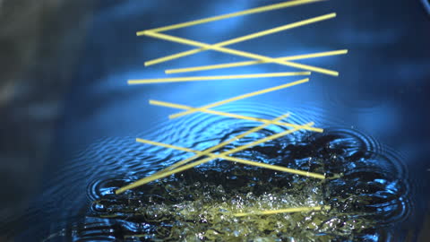 Spaghetti Dropping into Water in Slow Motion Splash