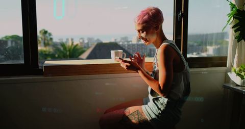 Woman Engaging with Smartphone Amidst Neon Data Graphics