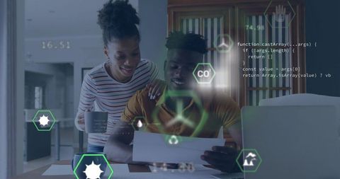 Young couple reviewing finances with augmented reality overlay on home workspace