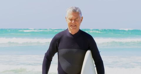 Senior Man Holding Surfboard on Sunny Beach Day - Download Free Stock Images Pikwizard.com