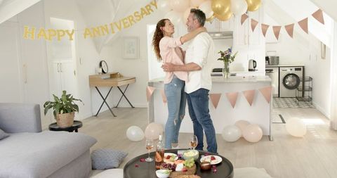 Happy Couple Celebrating Anniversary in Decorated Living Space