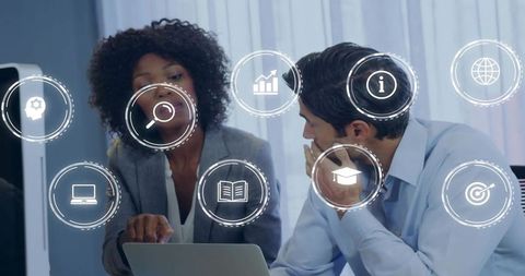 Business team collaborating over laptop with augmented reality icons for digital strategy