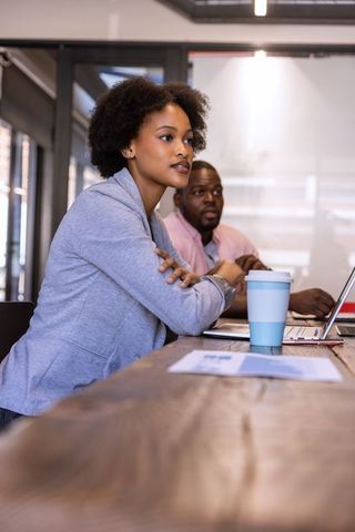 Colleagues Reviewing Document in Modern Office Environment