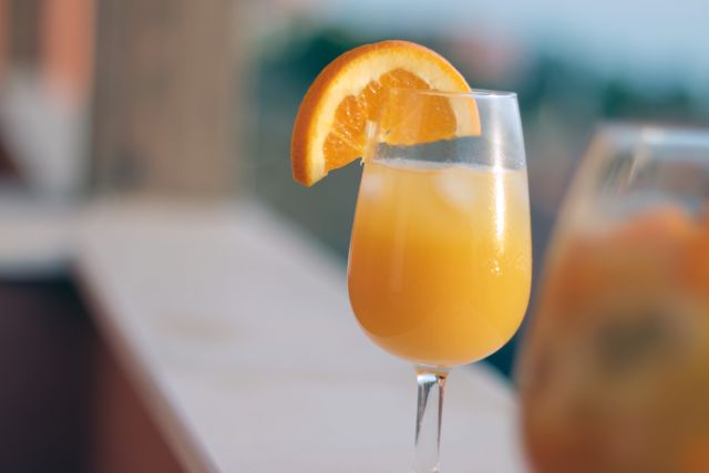Close-Up of Refreshing Orange Cocktail Garnished with Orange Slice - Download Free Stock Photos Pikwizard.com
