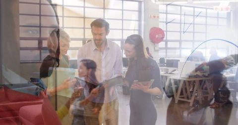 Team Collaboration in Modern Office with Tablet Discussion