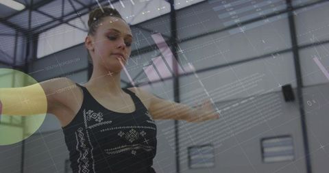 Teenage Athlete Balancing with Digital Analytics in Gymnasium