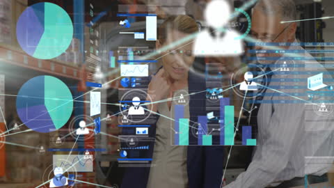 Coworkers Analyzing Financial Interface in Warehouse Environment