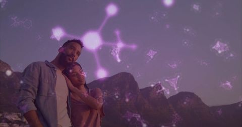 Couple leaning on shoulder overlooking coastal mountains at twilight with purple overlay