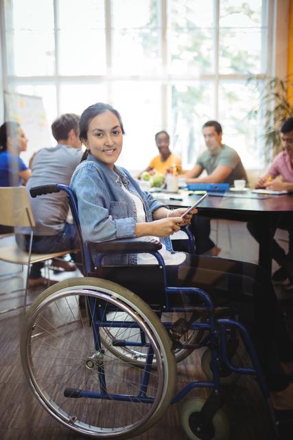 Confident Businesswoman in Wheelchair Using Digital Tablet in Office - Download Free Stock Images Pikwizard.com