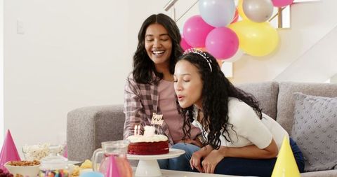 Women Celebrating Birthday with Cake and Balloons at Home