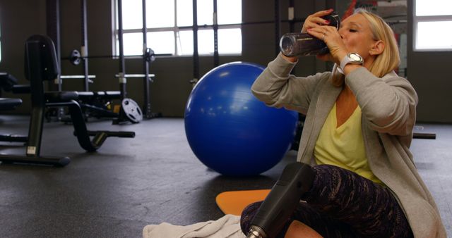 Senior Woman Hydrating After Workout in Gym - Download Free Stock Images Pikwizard.com