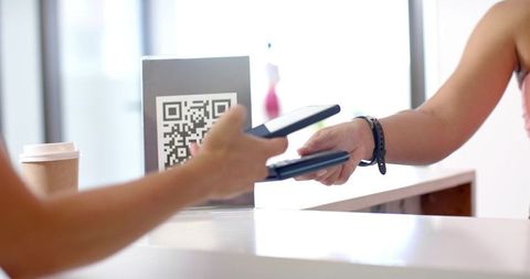 QR Code Payment by Biracial Woman with Smartphone Technology