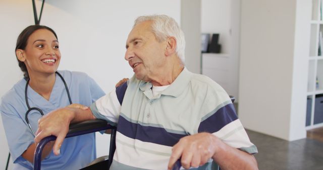 Caregiver with smile helping elderly man using walker in a home environment. Useful for promoting home care services, elderly support programs, residential healthcare, caregiver schedules, and medical assistance advertising.