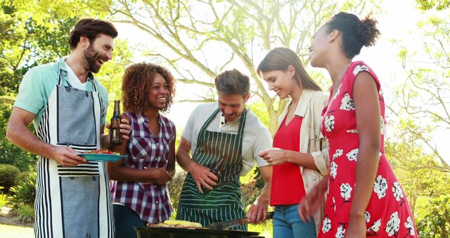 Friends Enjoying Barbecue Outdoors in Sunny Garden - Download Free Stock Images Pikwizard.com